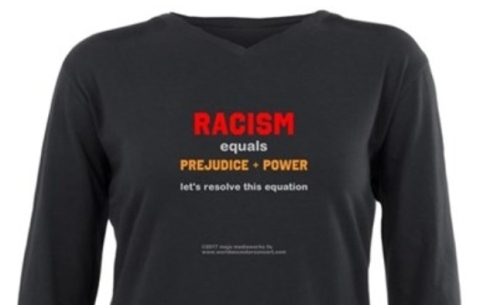 Cropped close-up image of long sleeve black t-shirt with messaging: "Racism = prejudice + power, let's resolve this equation"